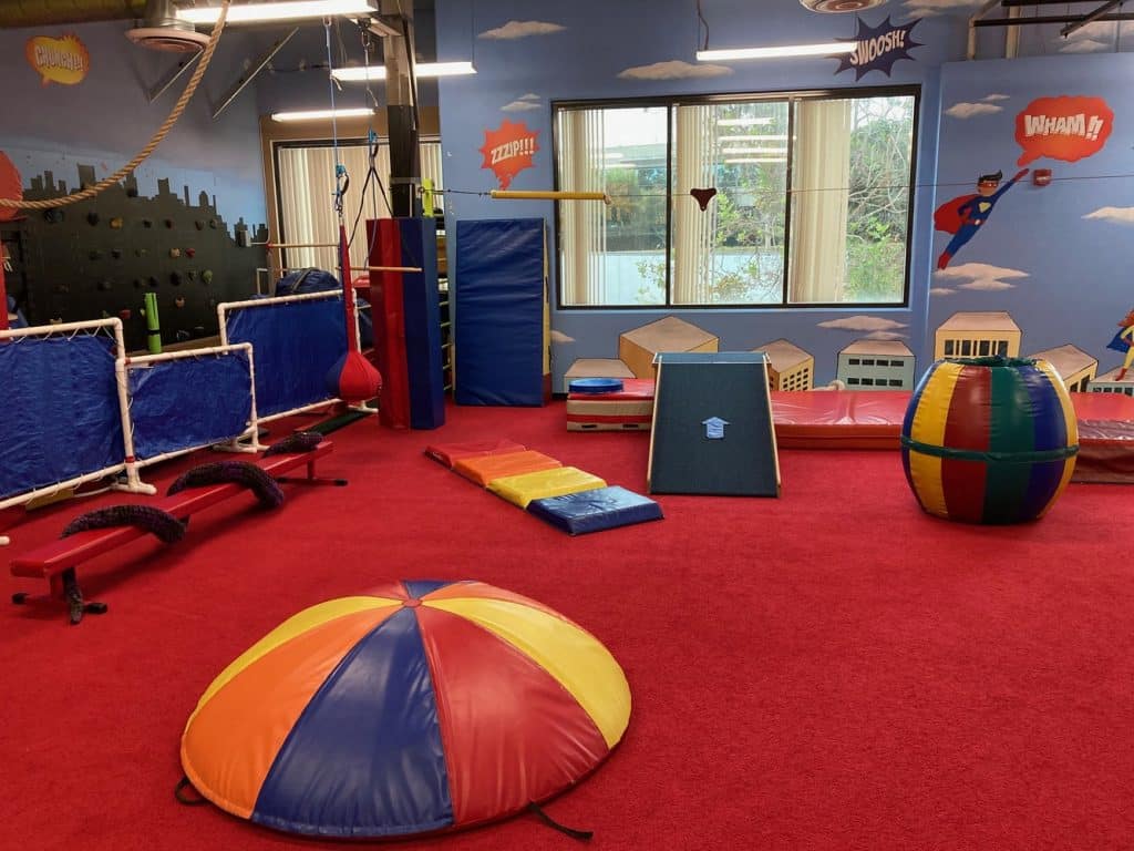 My Kids Place's colorful gym with balance beam, ramps, and swing | Physical Therapy in San Diego, CA