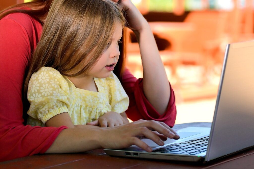 Child at computer with parent