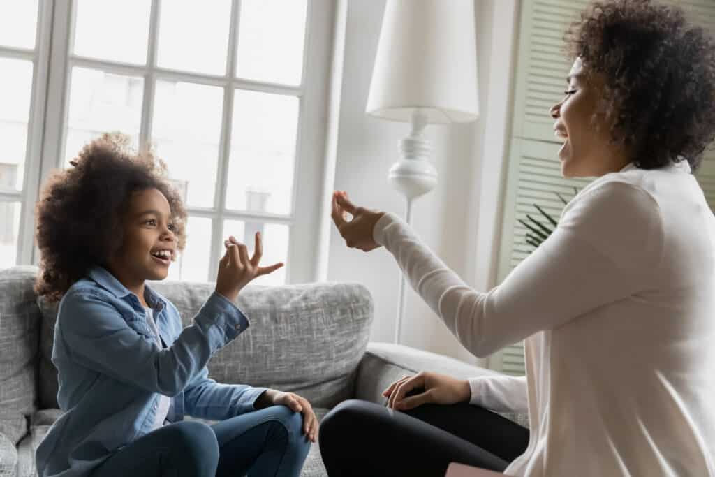 A speech therapist and a child practice different vocalizations while counting seconds on their fingers.